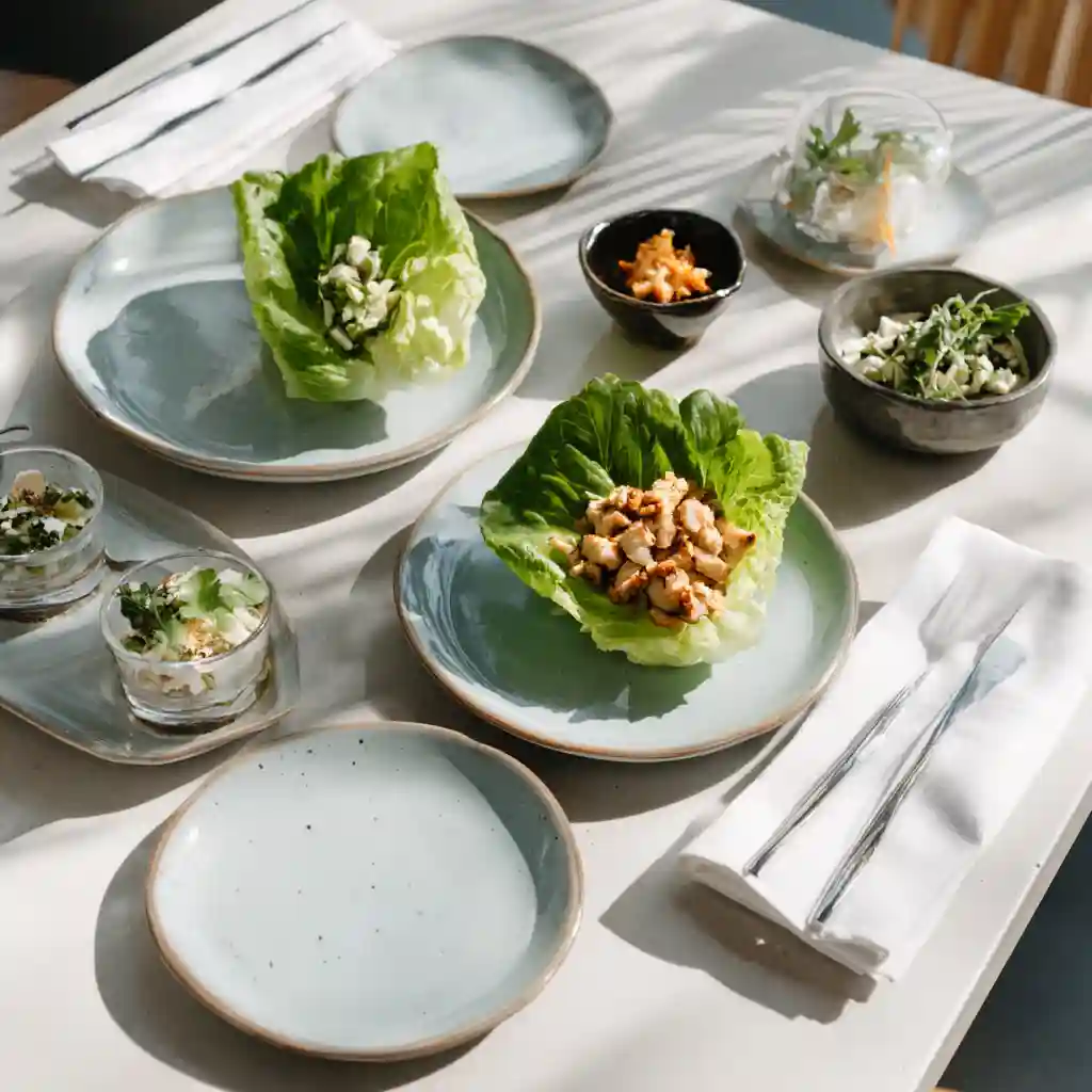 Chicken lettuce wraps served with sides on a table